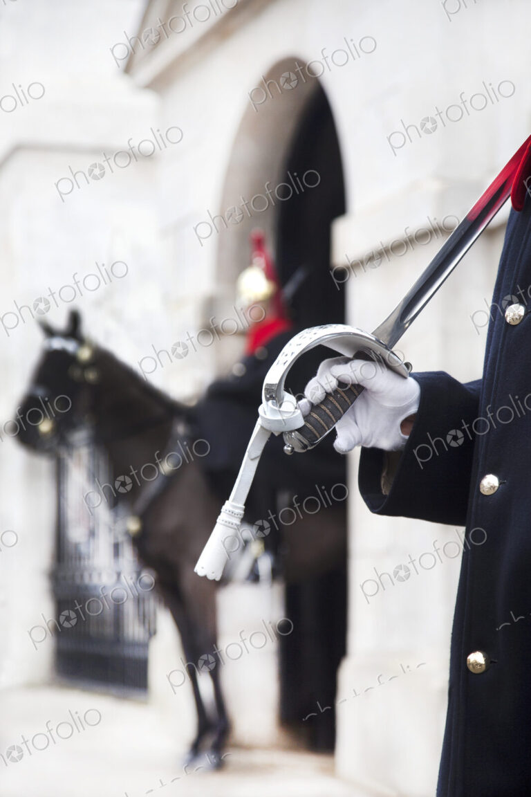 Close up of trooper at Horse Guards carrying sword on his shoulder, Whitehall, London,…
