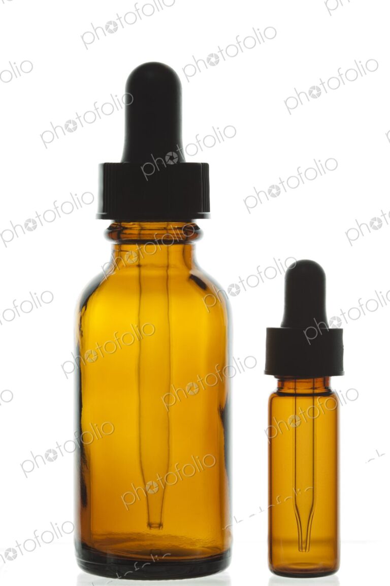 Close-up of two dropper bottles, often used to dispense alternative medicine…