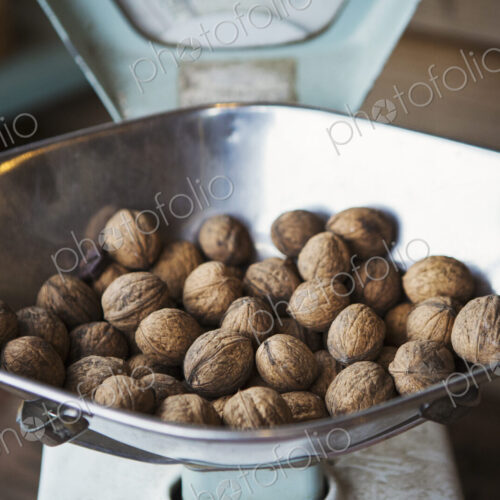 Close up of walnuts on metal weighing scales. Close up of walnuts on metal weighing scales.