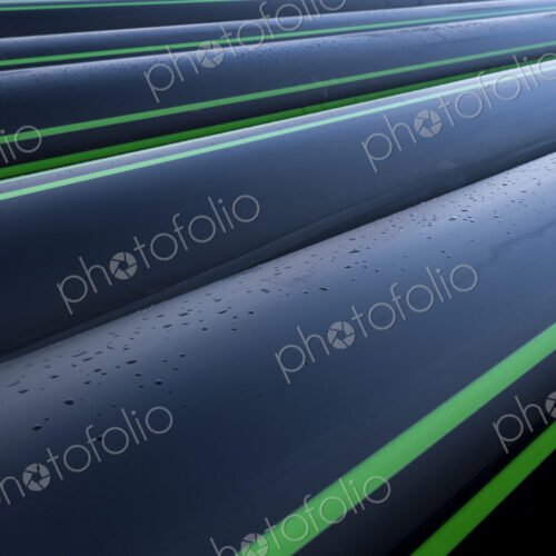 Close up of water pipes with water droplets.