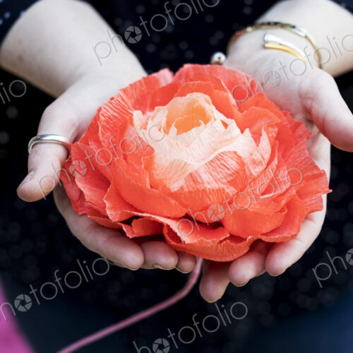 Close up of woman holding handcrafted fabric flowers.