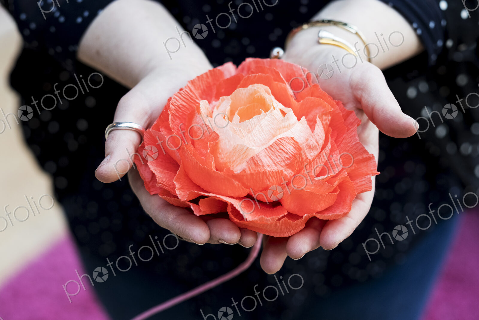 Close up of woman holding handcrafted fabric flowers.