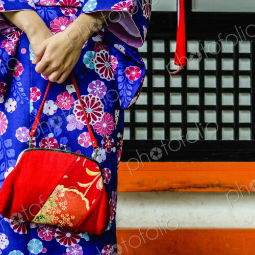 Close up of woman in kimono holding purse Close up of woman in kimono holding purse