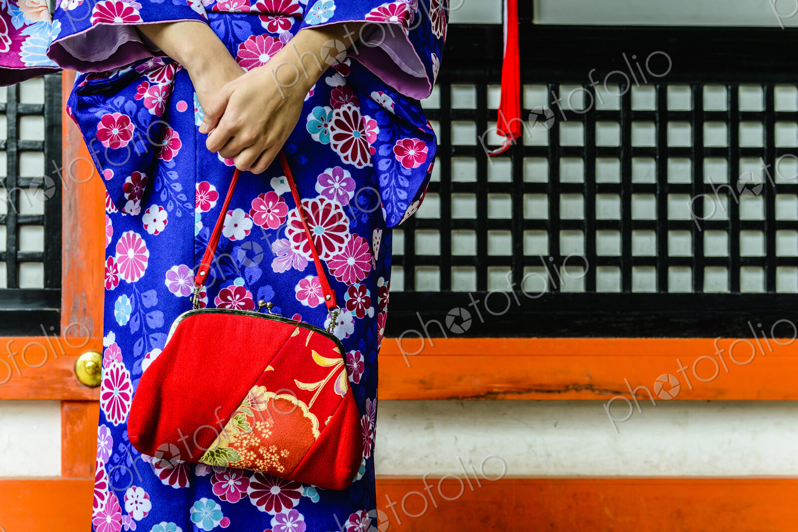 Close up of woman in kimono holding purse