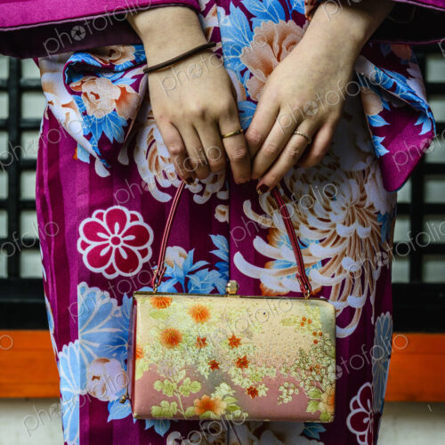 Close up of woman in kimono holding purse Close up of woman in kimono holding purse
