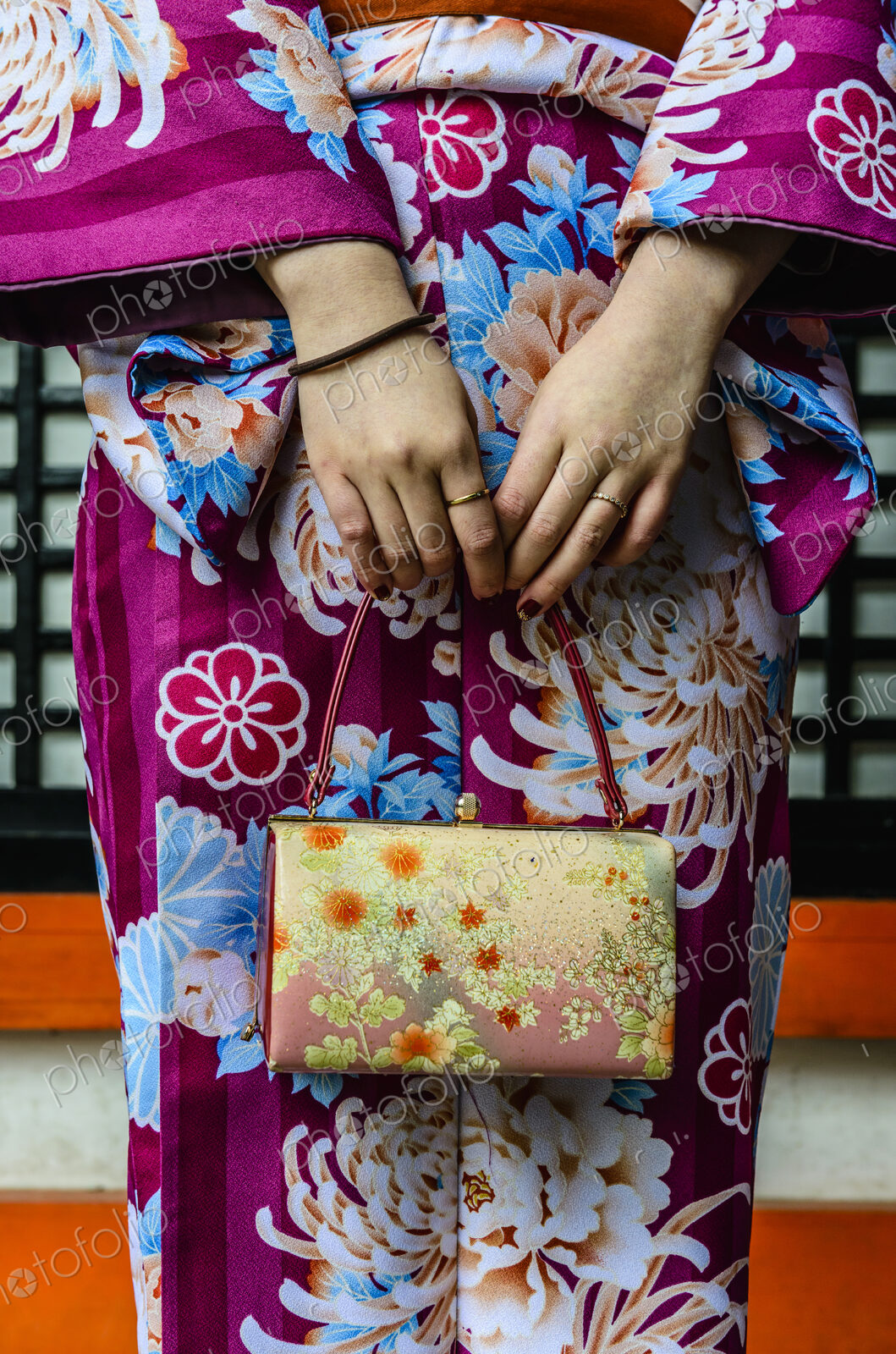 Close up of woman in kimono holding purse