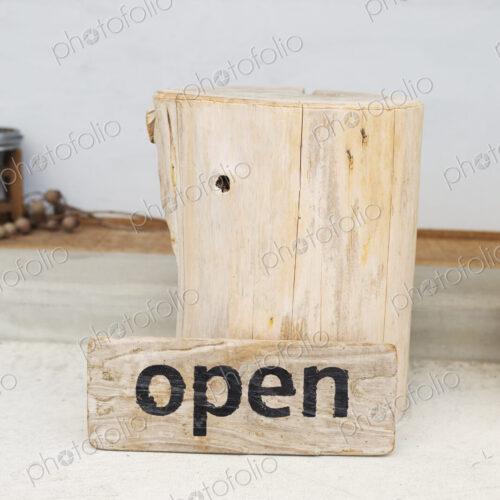 Close up of wooden Open sign in a vegetarian cafe. Close up of wooden Open sign in a vegetarian cafe.