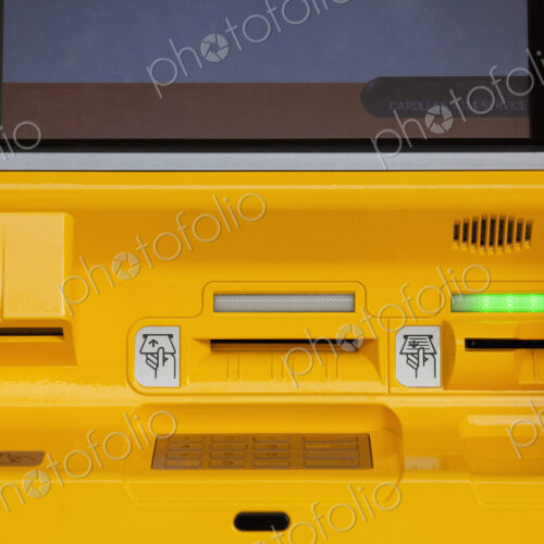 Close-up of yellow ATM machine.