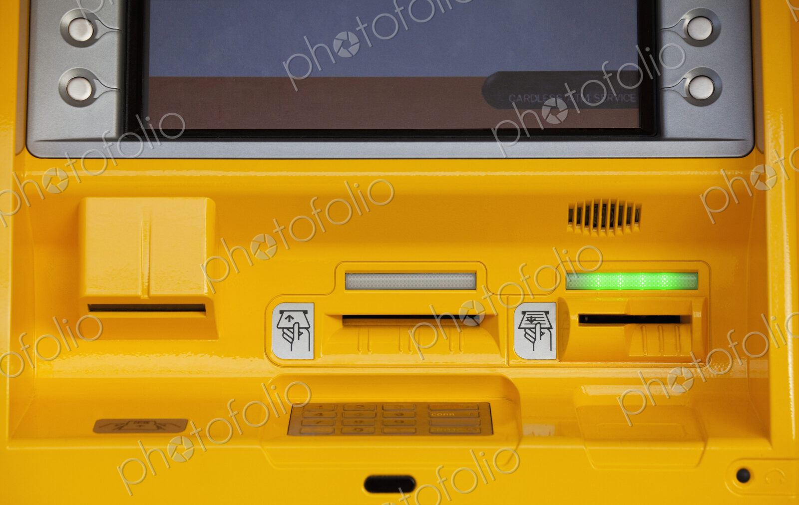 Close-up of yellow ATM machine.