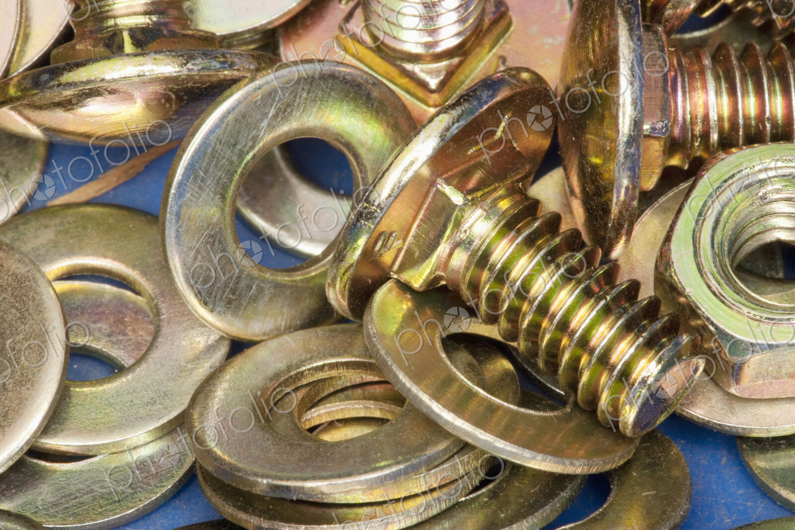 Close-up of yellow metal screws and washers.