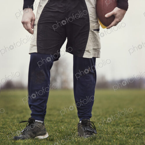 Close up view from the waist down of a male who is playing non-contact flag football. Close up view from the waist down of a male who is playing non-contact flag football.
