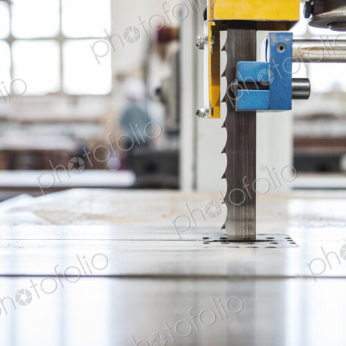 Close up view of a band saw in a woodworking factory.