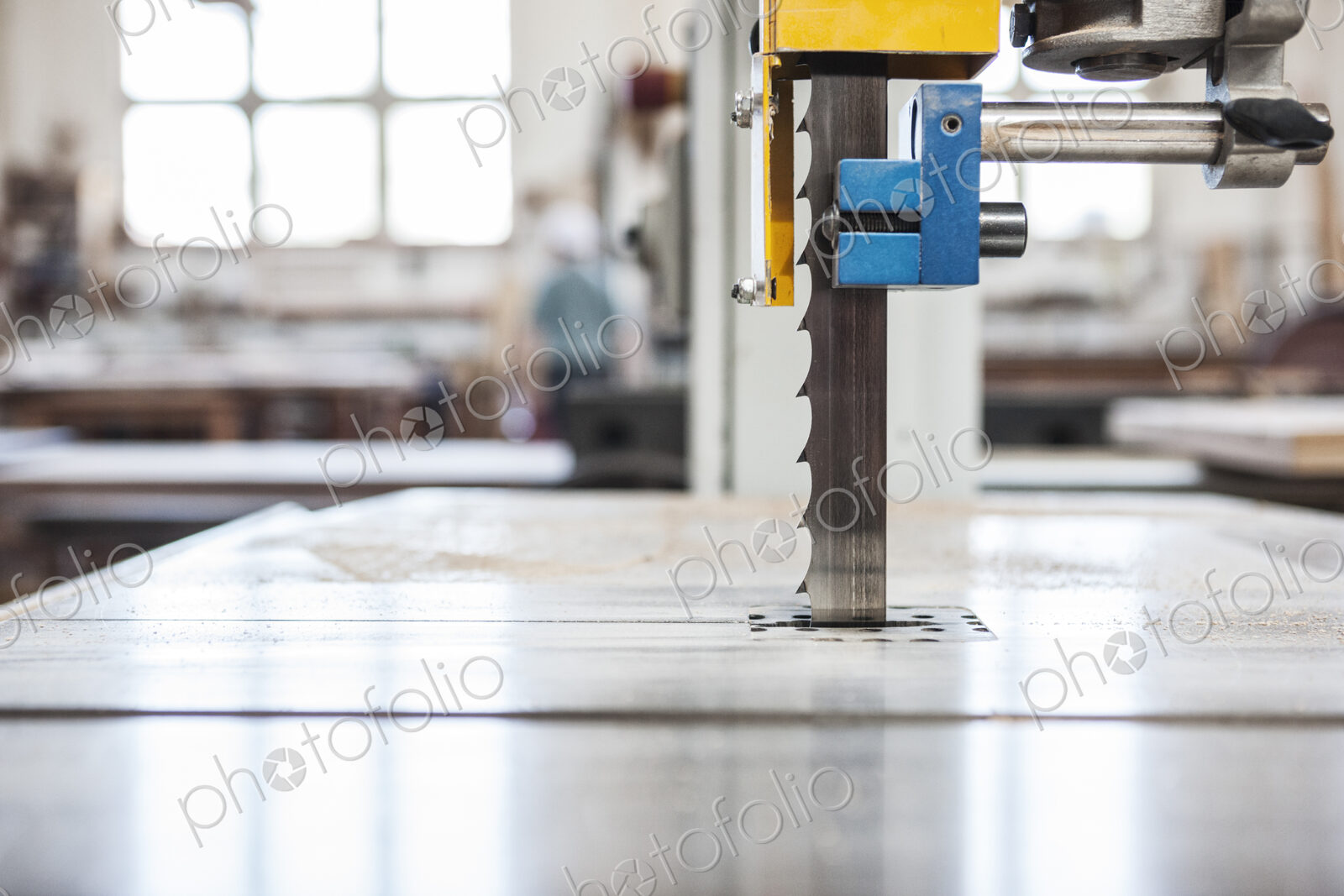 Close up view of a band saw in a woodworking factory.