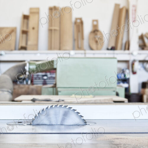 Close up view of a bank saw in a woodworking factory.