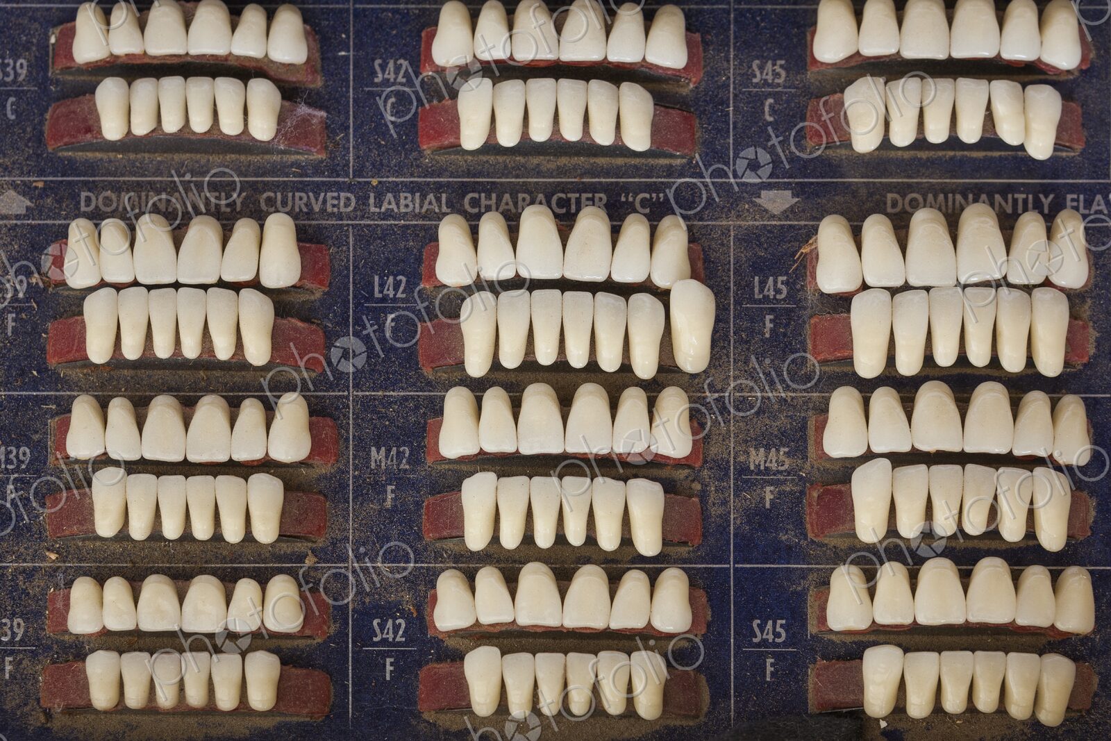 Close up view of rows of replacement teeth on a worn shade board in an old time…