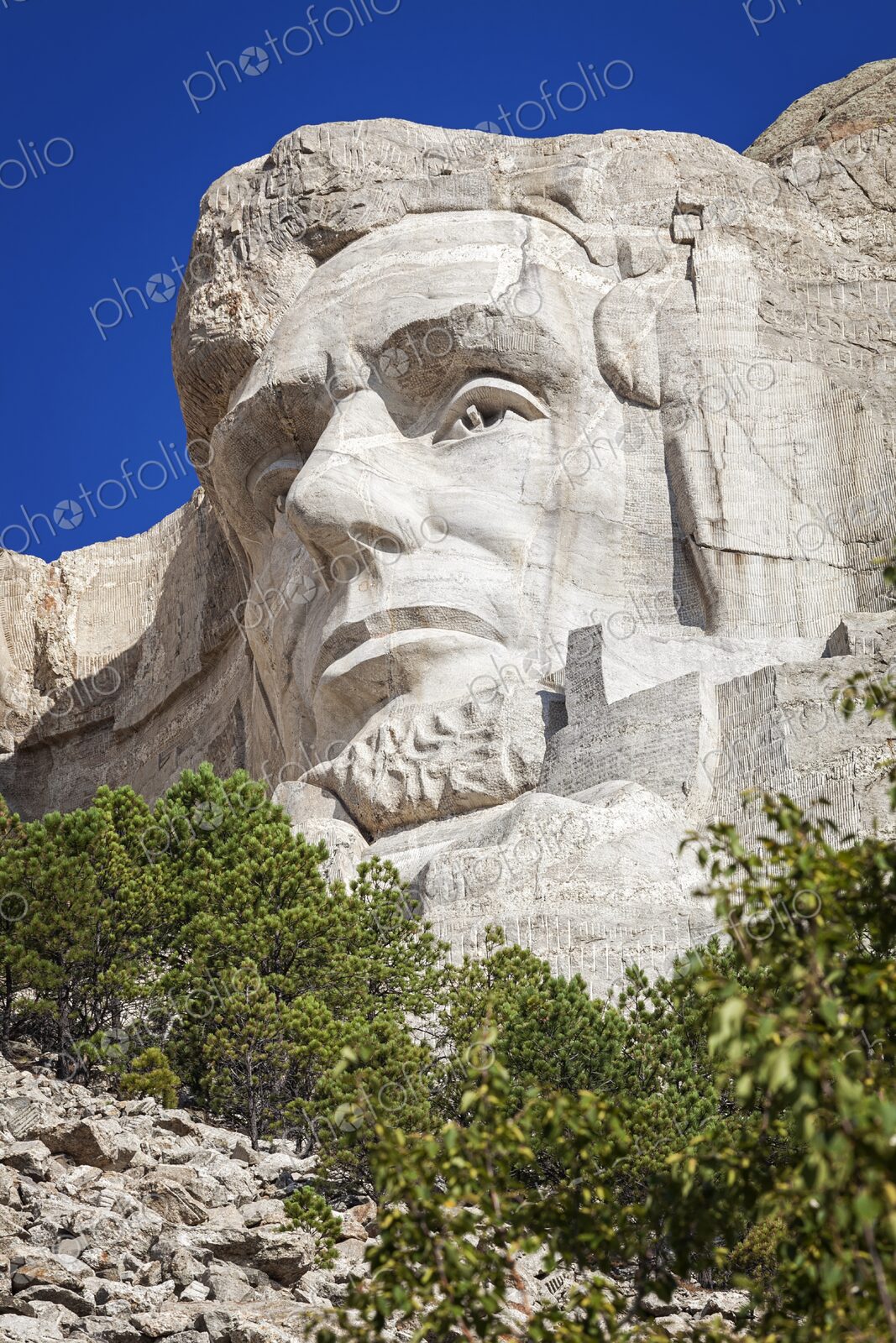 Close view of Abraham Lincoln carved in granite at Mount Rushmore National Memorial,…