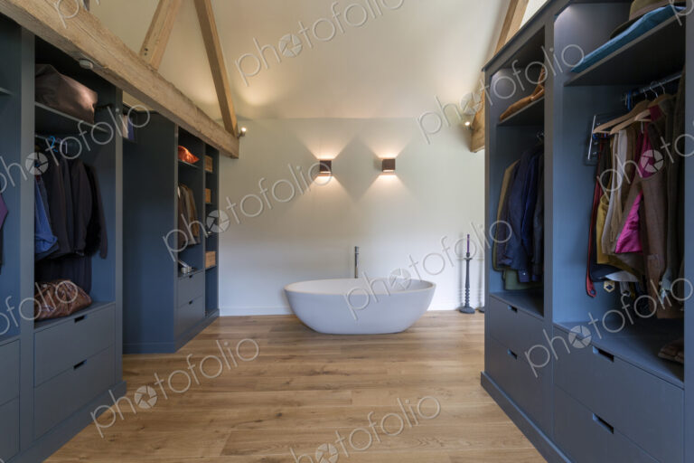 Closet and bathtub in modern bedroom