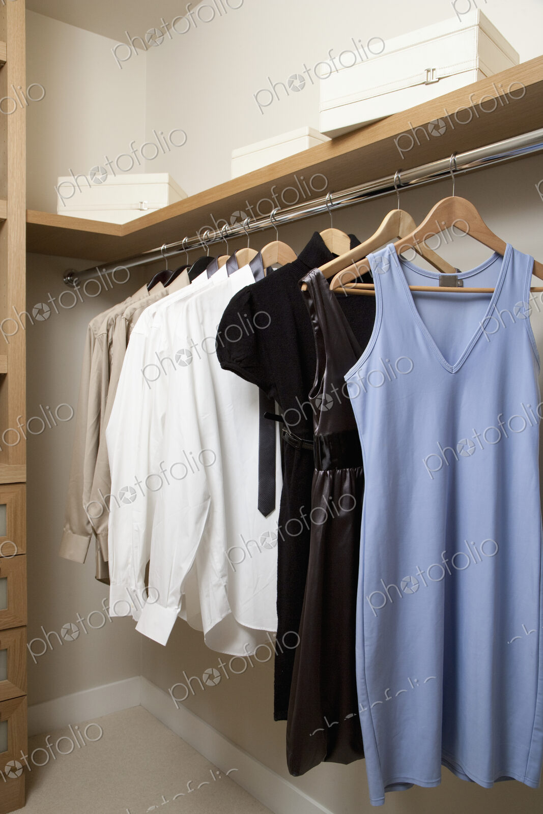 Closet with women’s clothes hanging on hangers