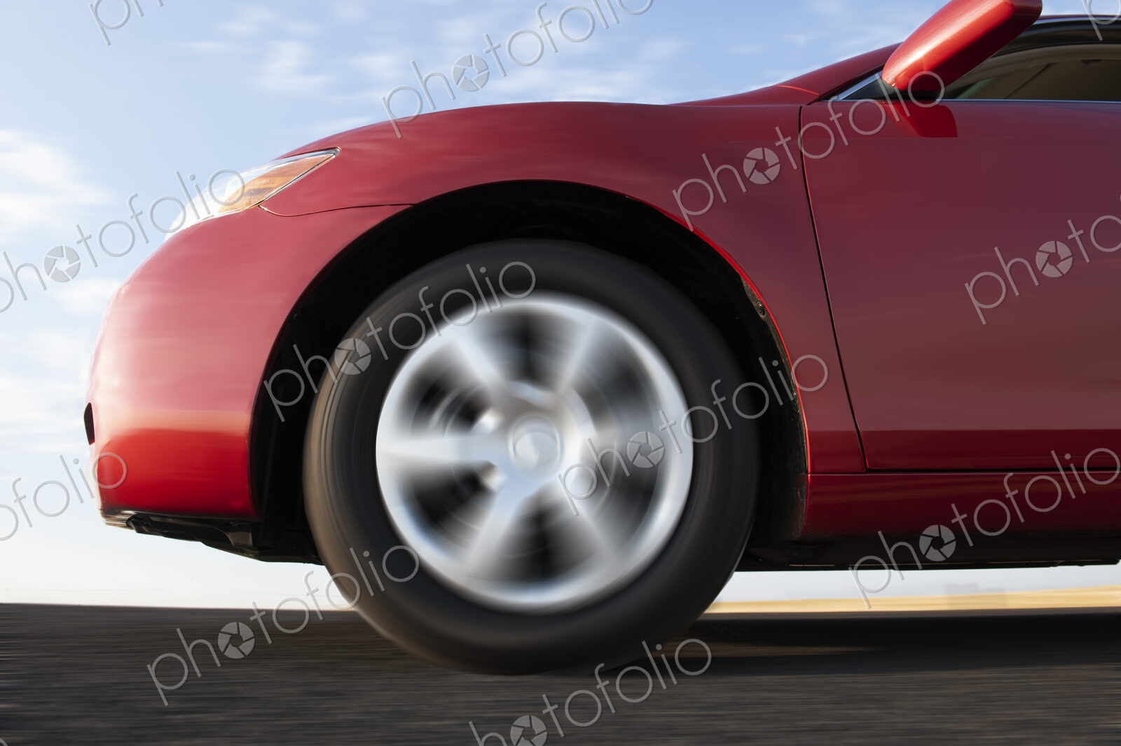 Closeup of a car tire on a highway.