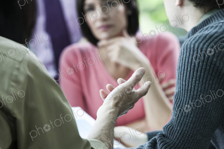 Closeup of a hand gesturing during a business meeting.