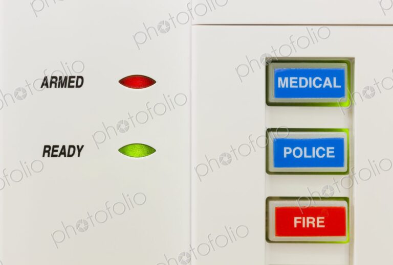 Closeup of alarm keypad showing the system is armed along with buttons for medical,…