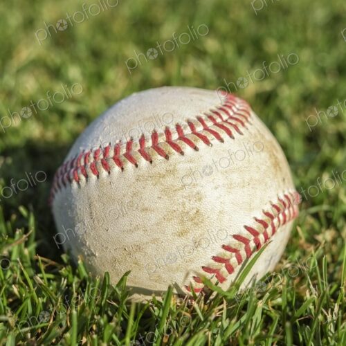 Closeup of baseball on lush green grass Closeup of baseball on lush green grass