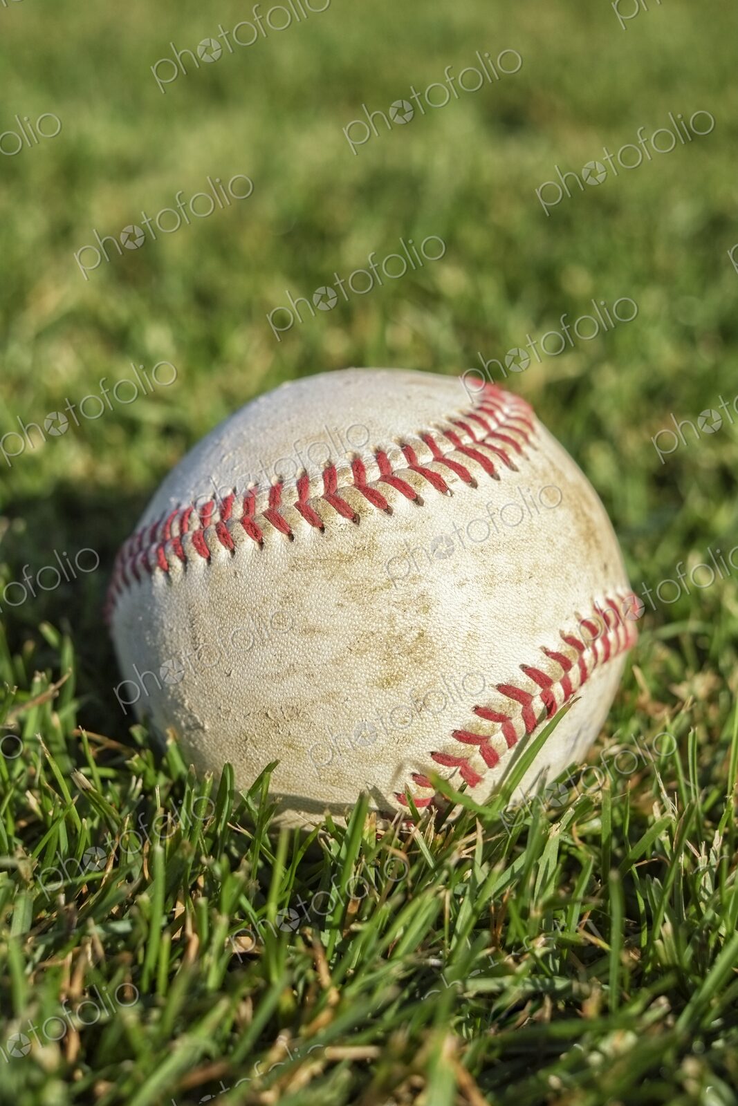 Closeup of baseball on lush green grass