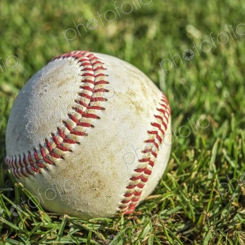 Closeup of baseball on lush green grass Closeup of baseball on lush green grass
