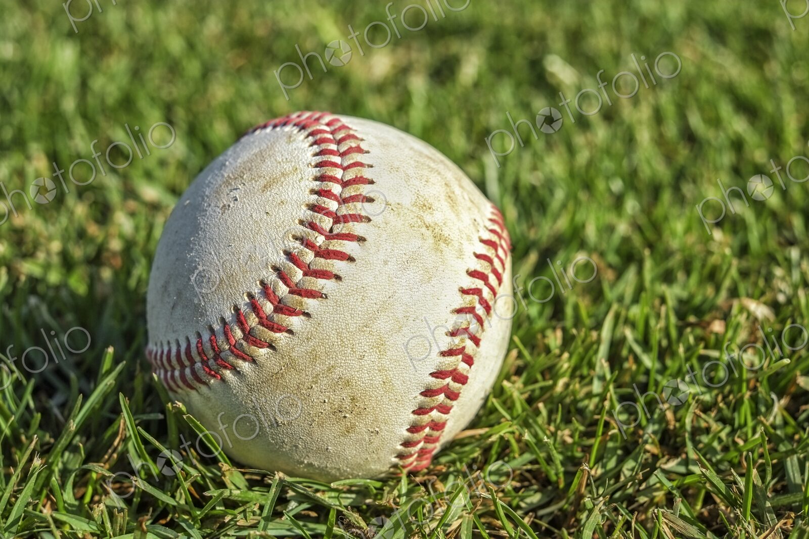 Closeup of baseball on lush green grass