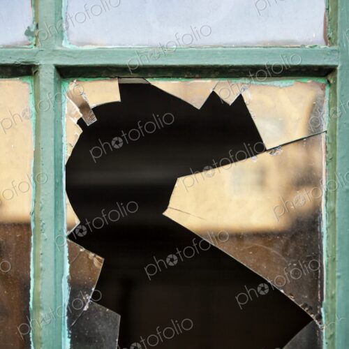 Closeup of broken glass in window pane Closeup of broken glass in window pane