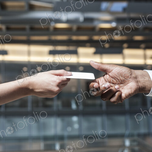 Closeup of hands and a credit card transaction taking place. Closeup of hands and a credit card transaction taking place.