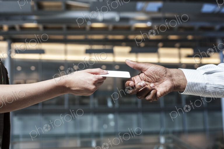 Closeup of hands and a credit card transaction taking place.
