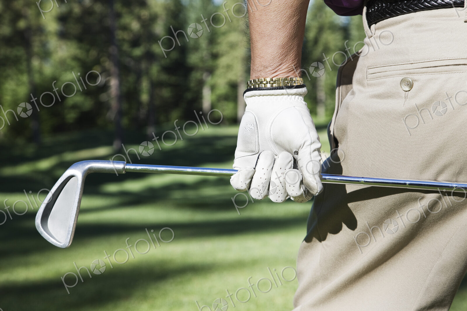 Closeup of hands and golf club.