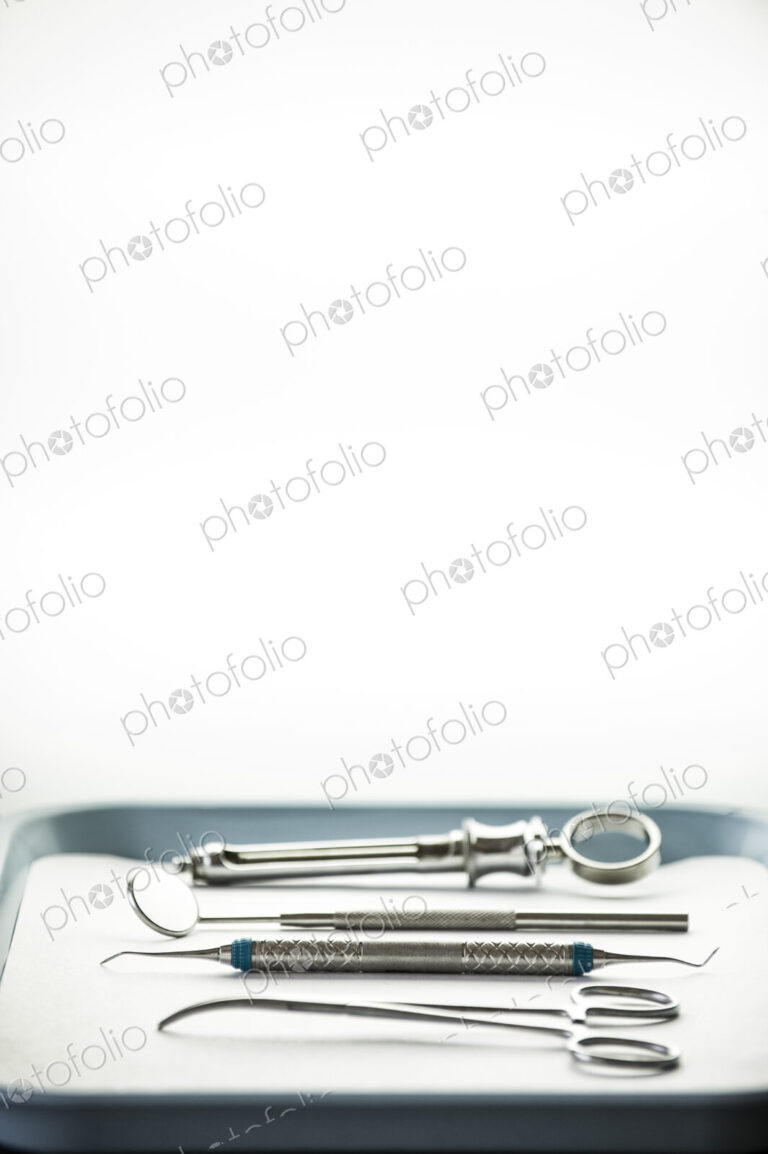 Closeup of medical tools on a tray in a dental surgery.