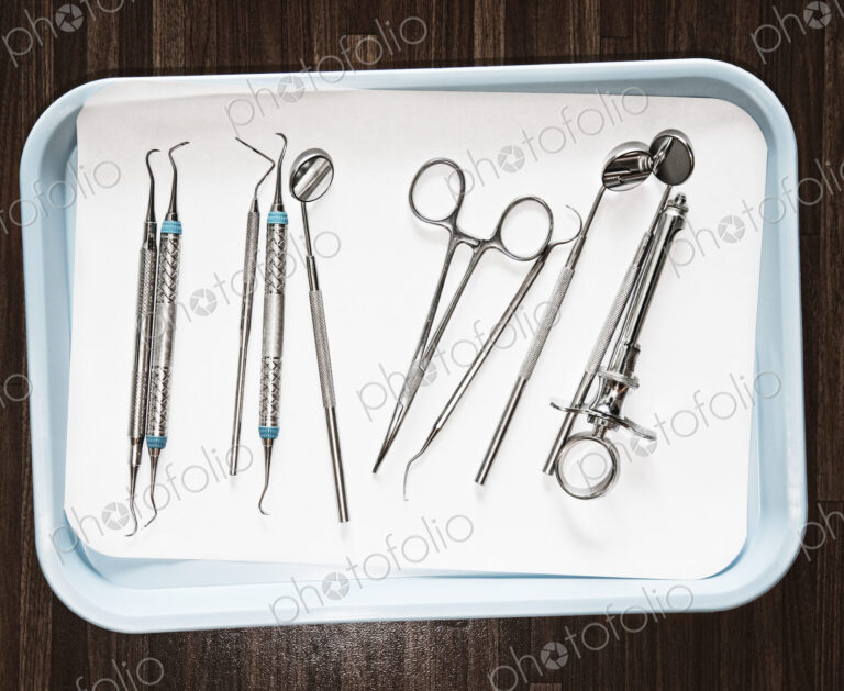 Closeup of medical tools on a tray in a dental surgery.