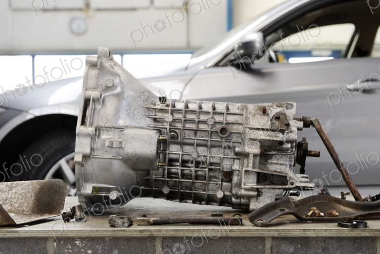 Closeup of motor gear shaft from a car engine at an auto repair shop.