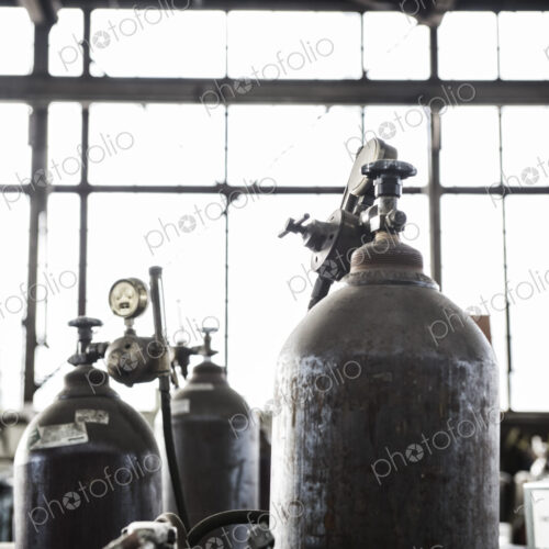 Closeup of oxyacetylene gas welding tanks in a sheet metal factory. Closeup of oxyacetylene gas welding tanks in a sheet metal factory.