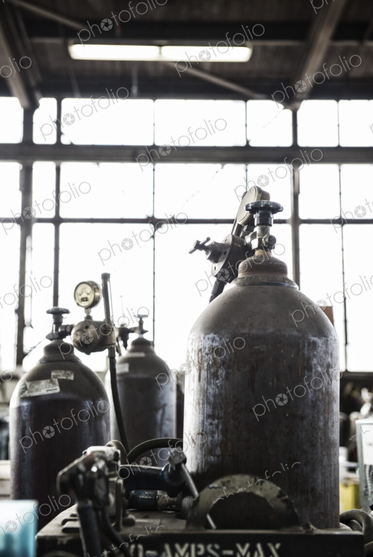 Closeup of oxyacetylene gas welding tanks in a sheet metal factory.