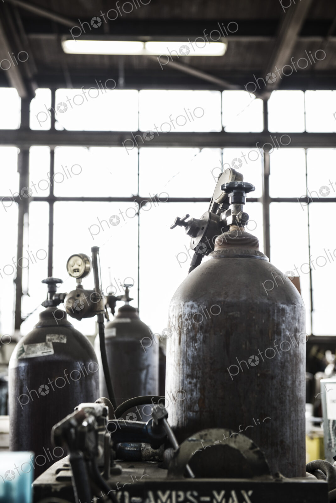 Closeup of oxyacetylene gas welding tanks in a sheet metal factory.