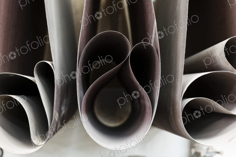 Closeup of sanding belts ready to be used in a wood working shop.