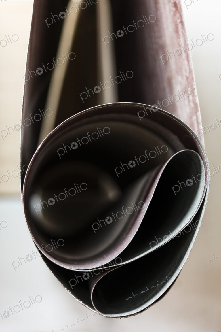 Closeup of sanding belts ready to be used in a wood working shop.