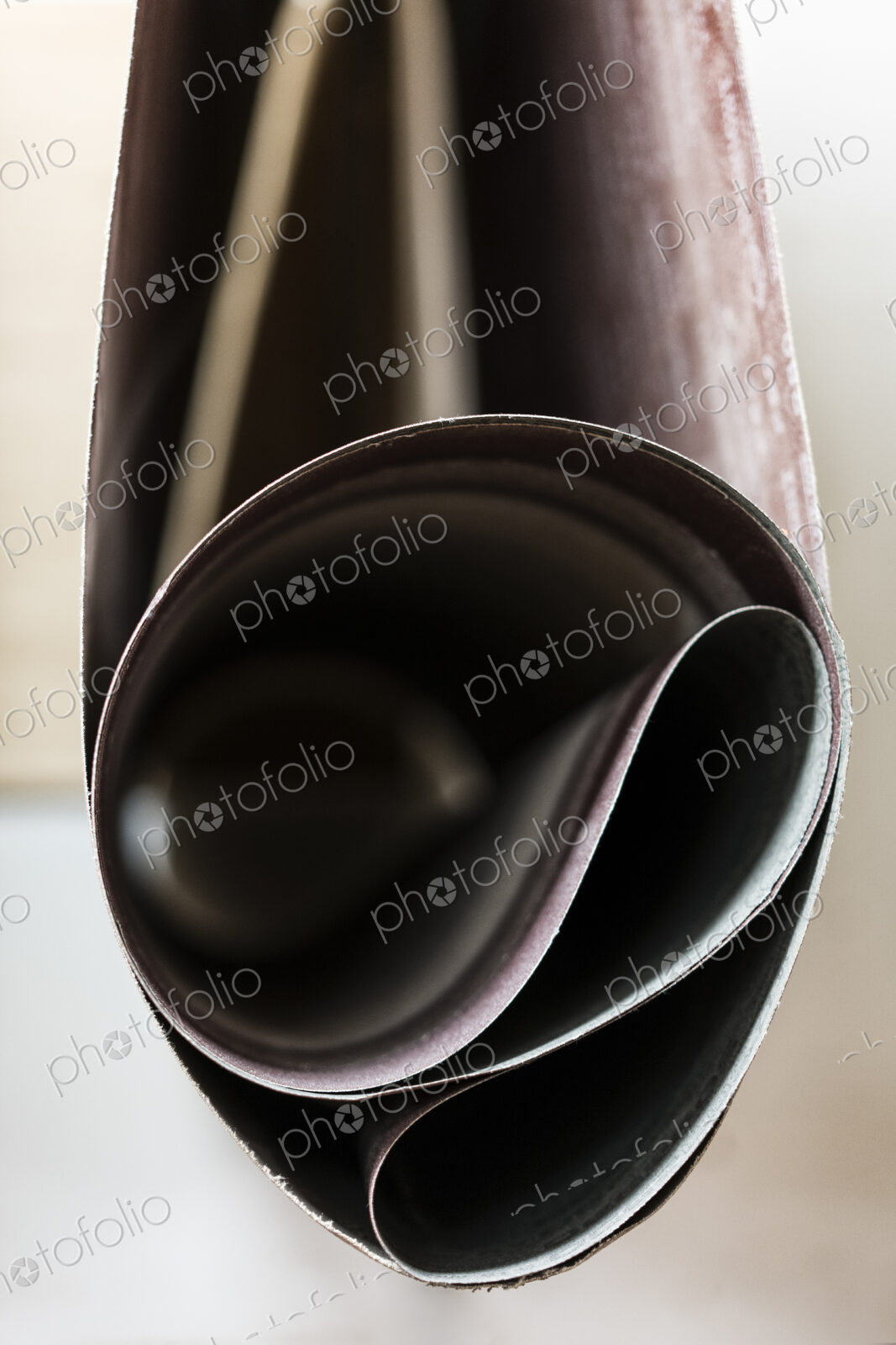 Closeup of sanding belts ready to be used in a wood working shop.
