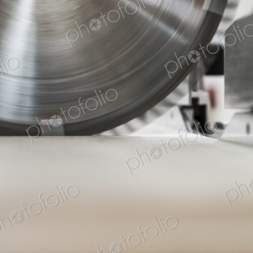Closeup of the blade on a radial saw in a woodworking factory. Closeup of the blade on a radial saw in a woodworking factory.