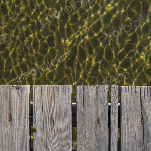 Closeup of wooden dock, clear waters of Lake Tahoe below, High Sierra, CA, USA Closeup of wooden dock, clear waters of Lake Tahoe below, High Sierra, CA, USA