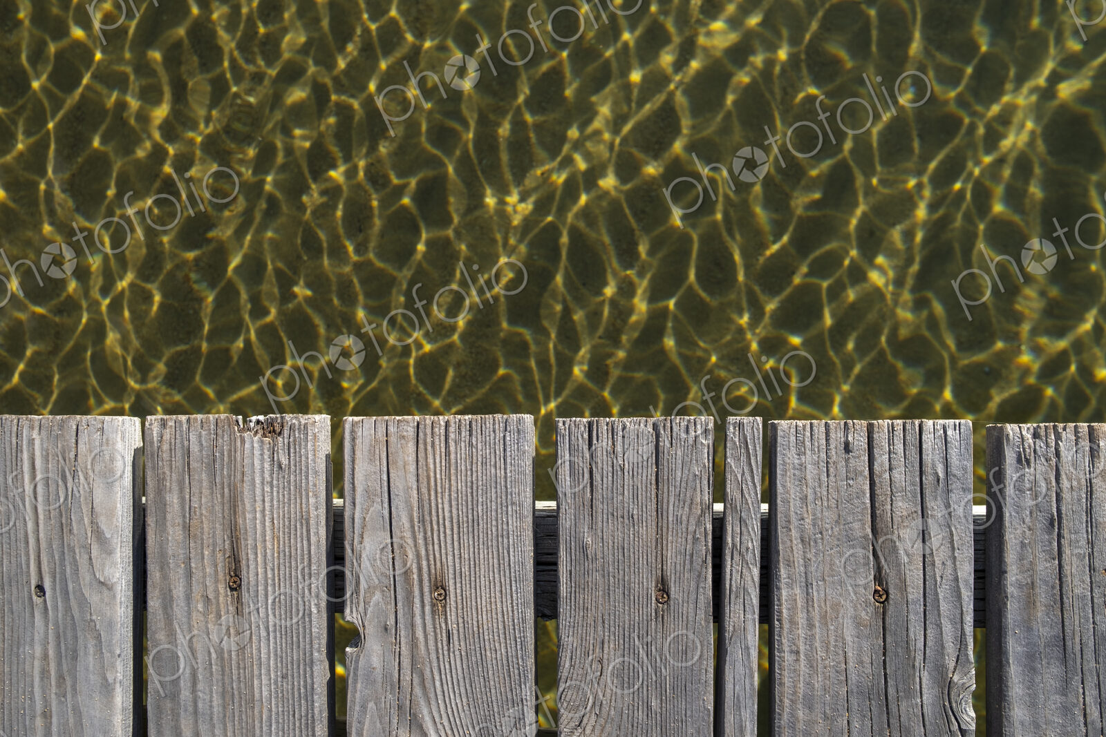 Closeup of wooden dock, clear waters of Lake Tahoe below, High Sierra, CA, USA