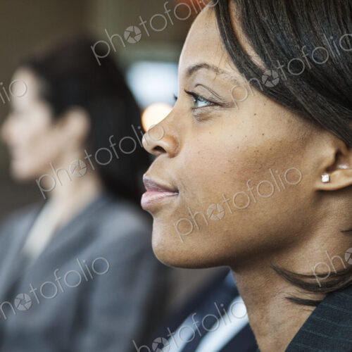 Closeup side view portrait of a black businesswoman in a meeting. Closeup side view portrait of a black businesswoman in a meeting.