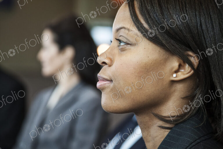 Closeup side view portrait of a black businesswoman in a meeting.