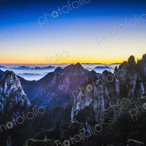 Clouds rolling over rocky mountains, Huangshan, Anhui, China Clouds rolling over rocky mountains, Huangshan, Anhui, China