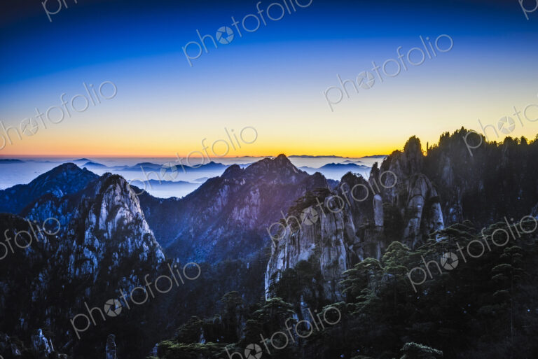 Clouds rolling over rocky mountains, Huangshan, Anhui, China