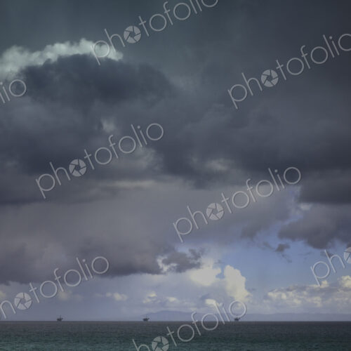 Cloudy dark sky above rural landscape.